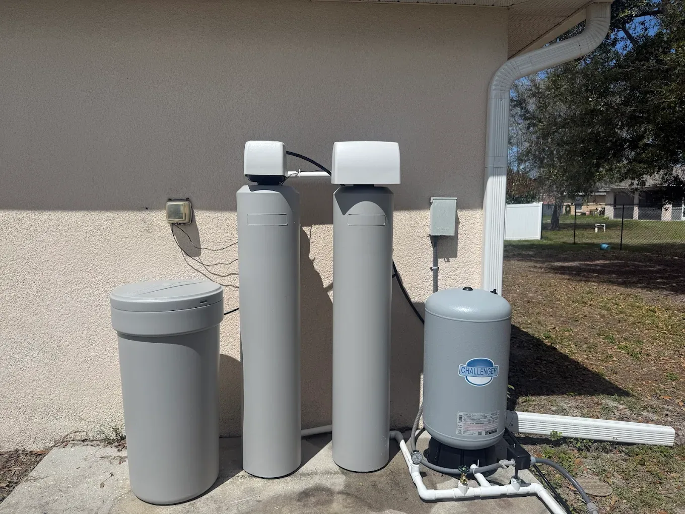 Outdoor well pump and water treatment equipment serviced by Oasis Well Service